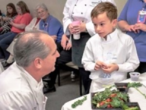 Tim Creehan speaks with a young boy aspiring to be a chef